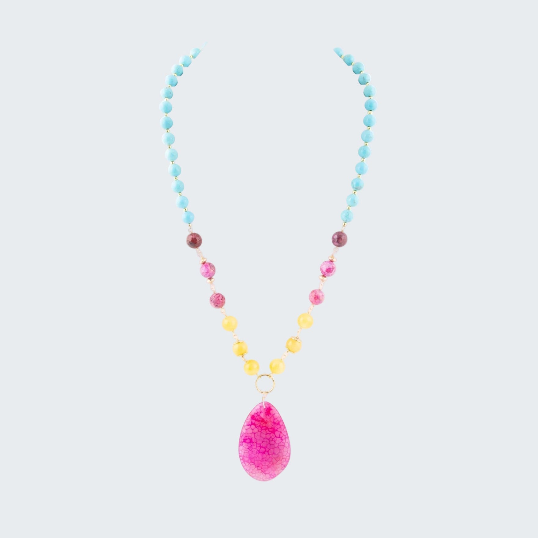 Necklace with colorful beads and a pink teardrop pendant on a white background