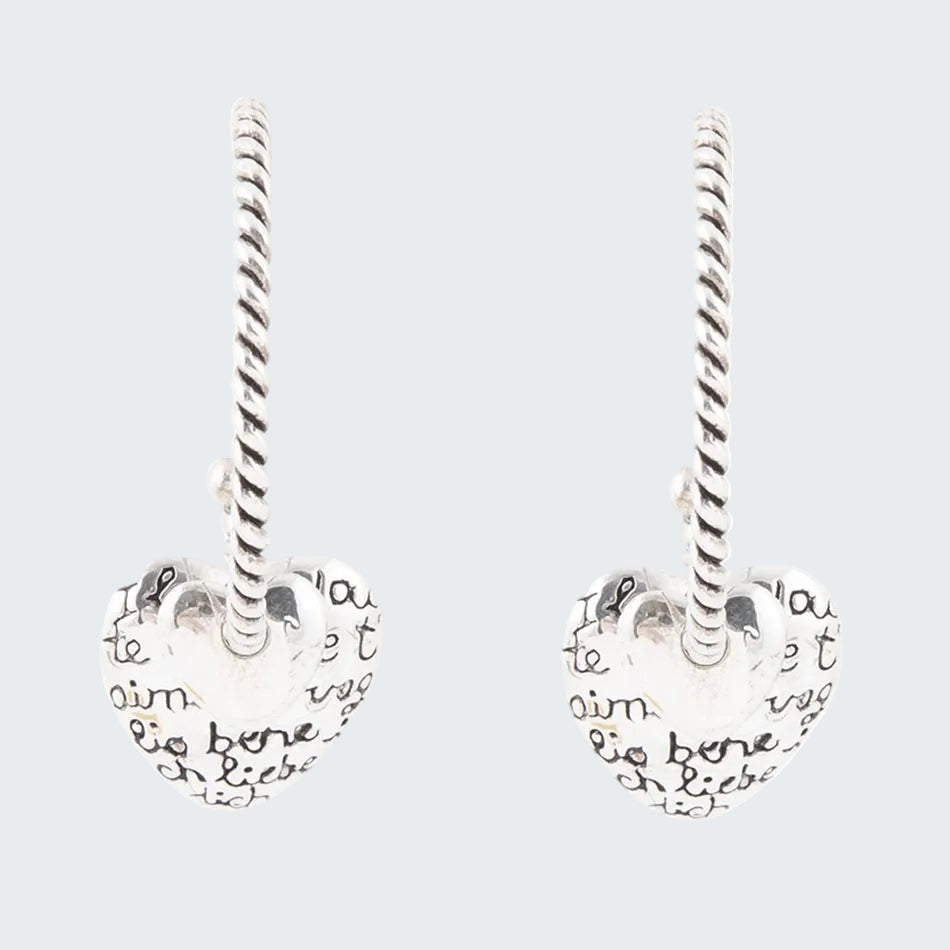 Heart-shaped earrings with engraved text on a white background