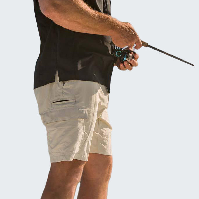 Person wearing beige shorts and a black sleeveless shirt, holding a fishing rod on a white background
