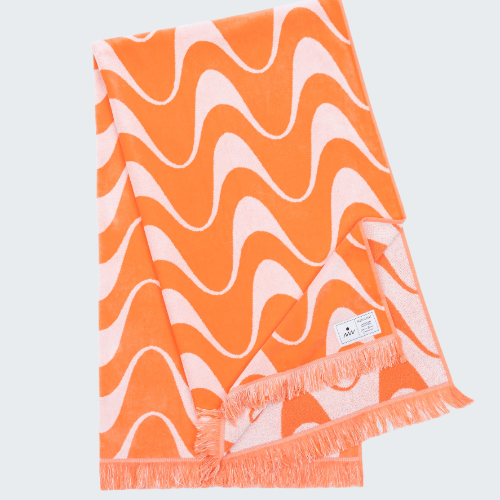 Orange and pink wavy patterned towel on a white background