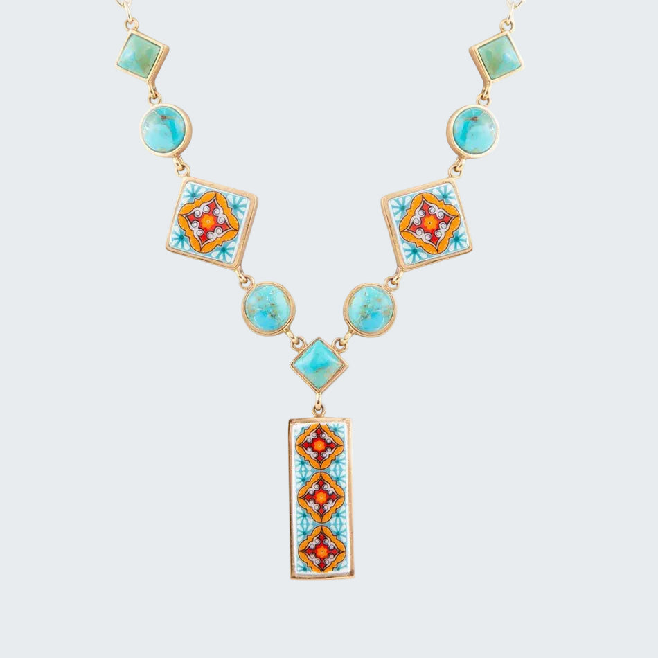 Necklace with geometrically patterned turquoise and orange stones on a white background