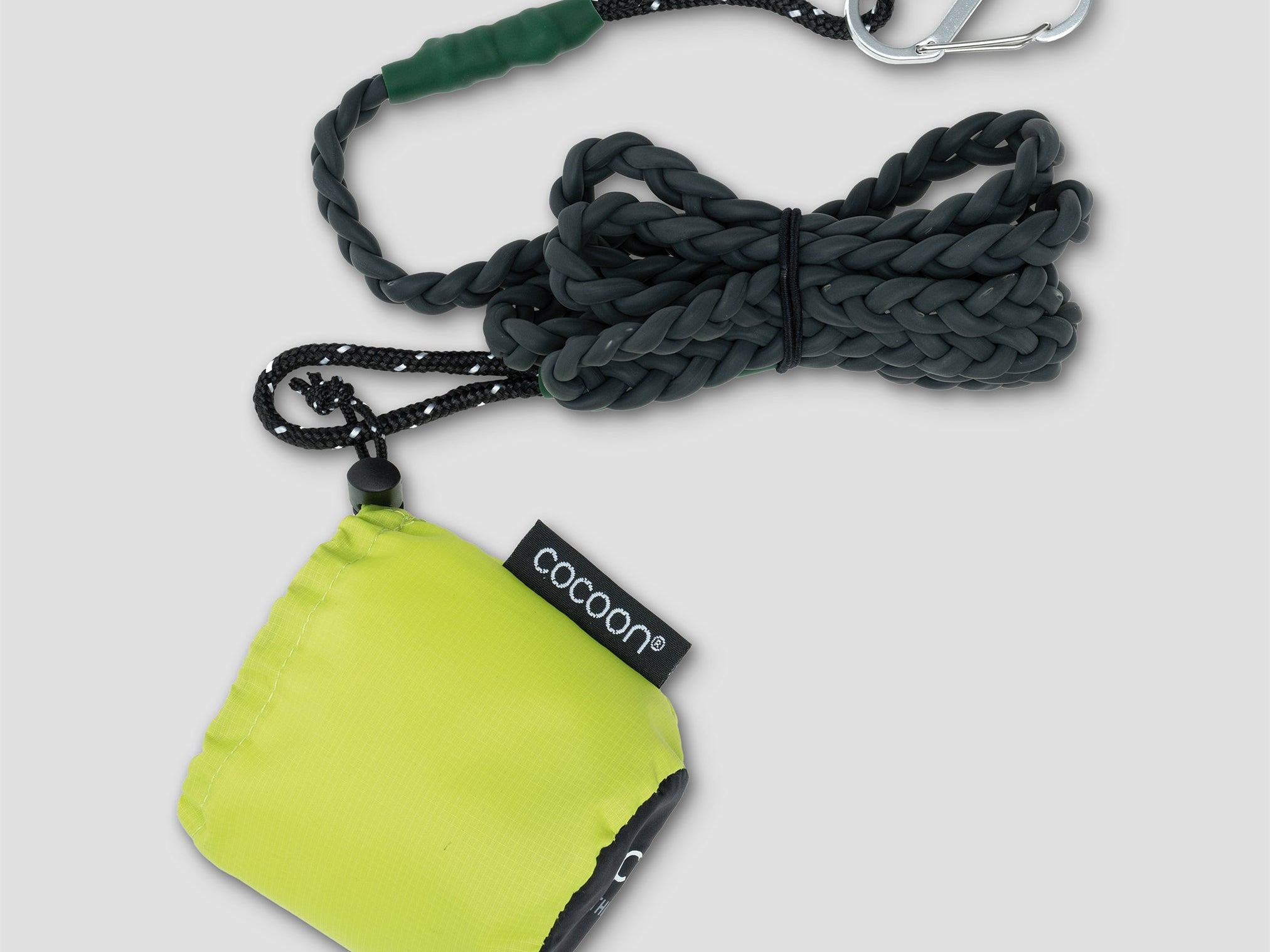 Green pouch with rope and carabiner on a light gray background