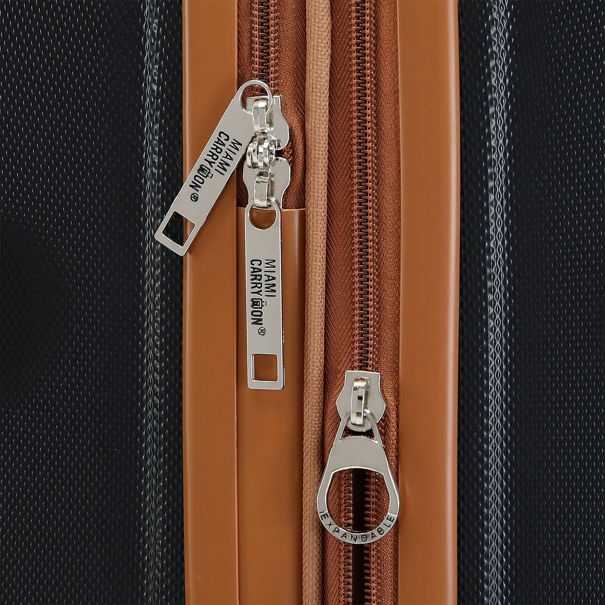 Close-up of a brown zipper on a textured surface with visible brand name.
