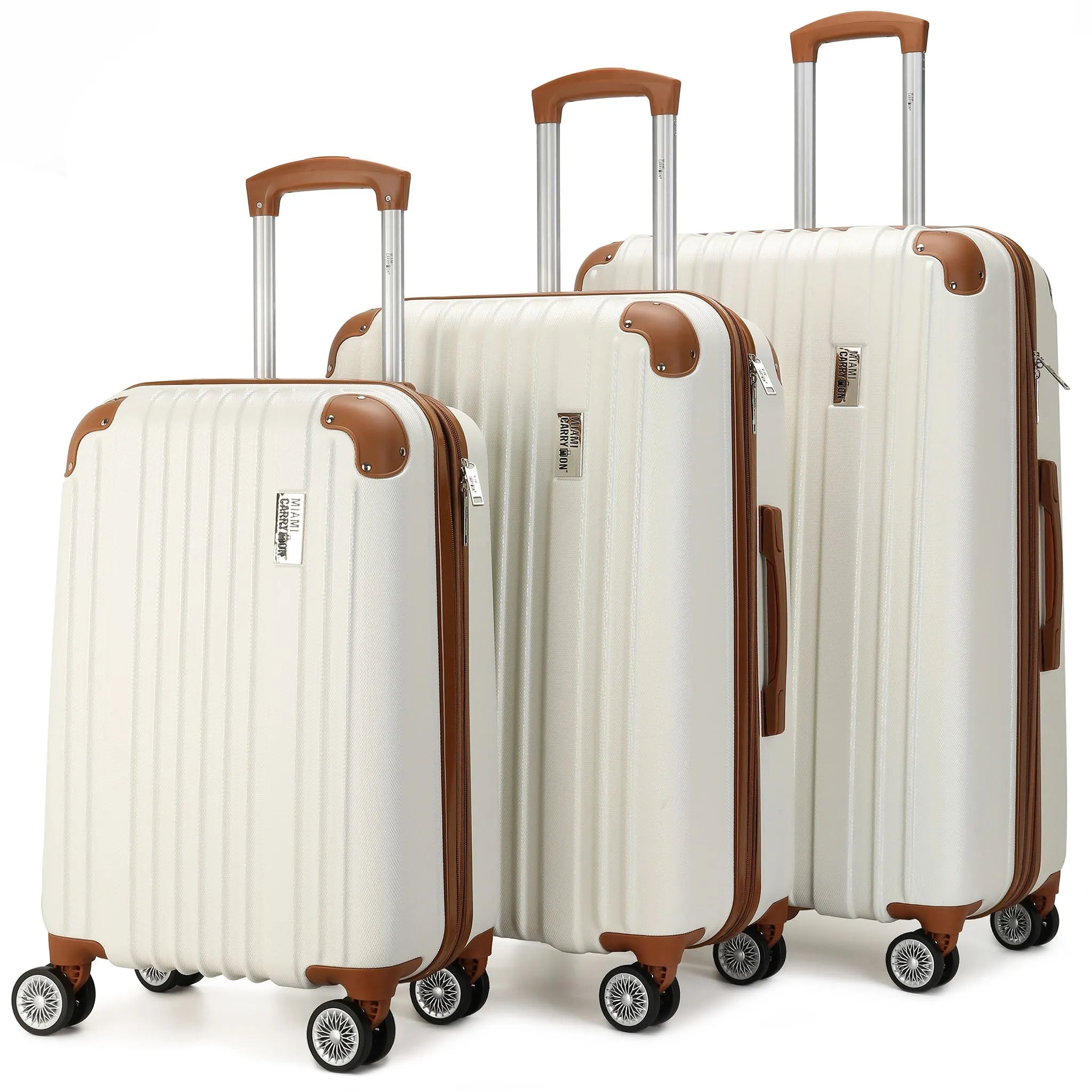 Set of three white suitcases with brown accents on a white background