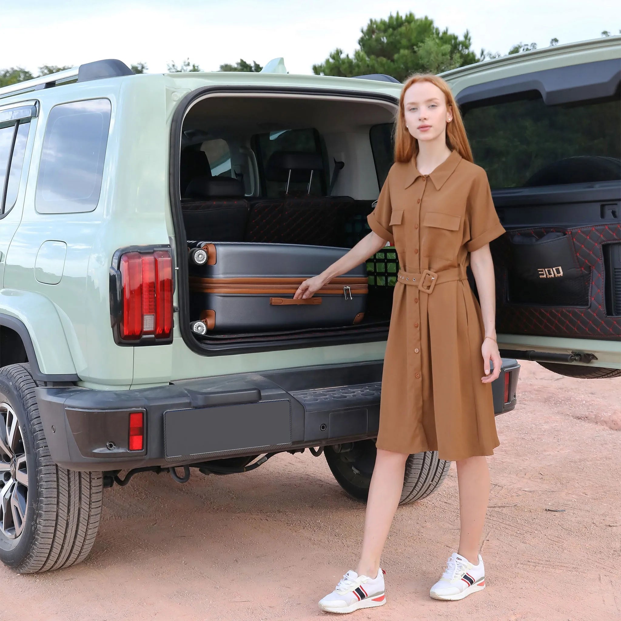 Woman in a brown dress standing next to an open car trunk with a suitcase.