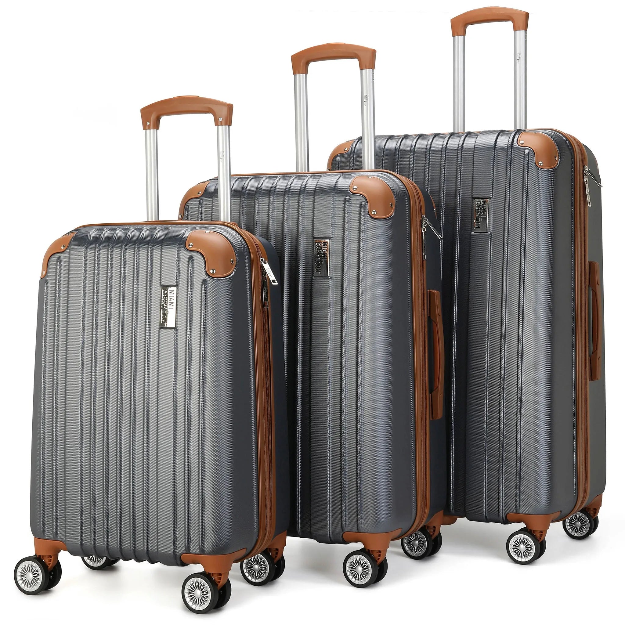 Set of three gray suitcases with brown handles and accents on a white background