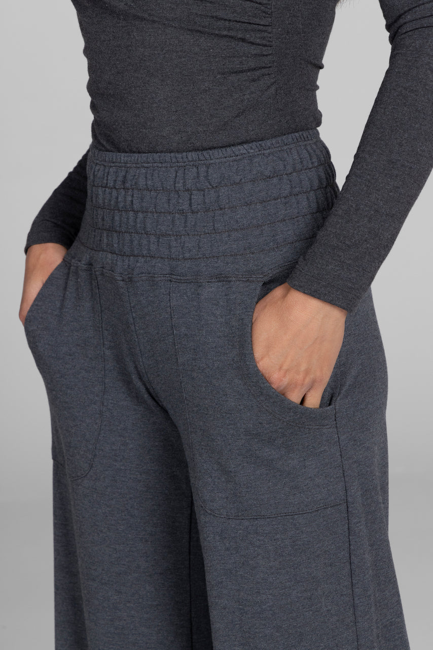 Dark gray pants with a plain background