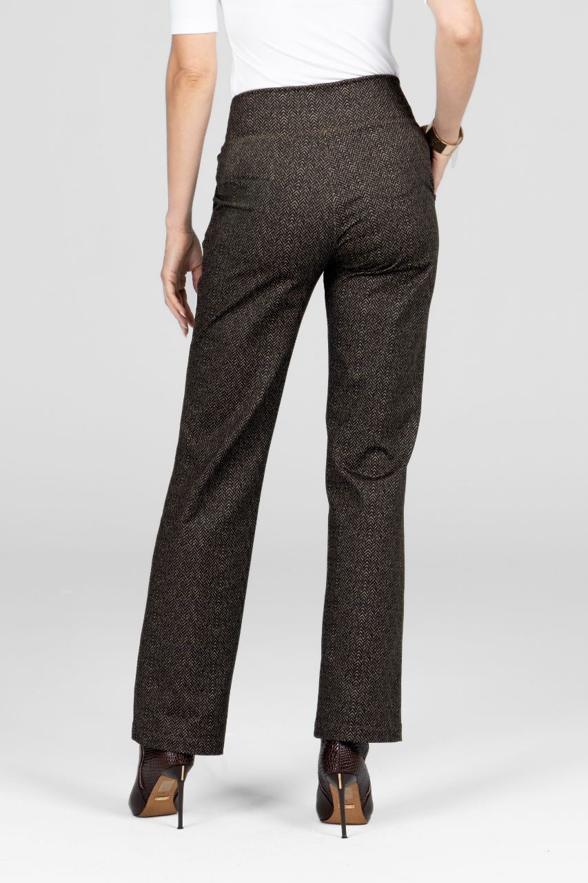Dark patterned pants worn by a person on a white background