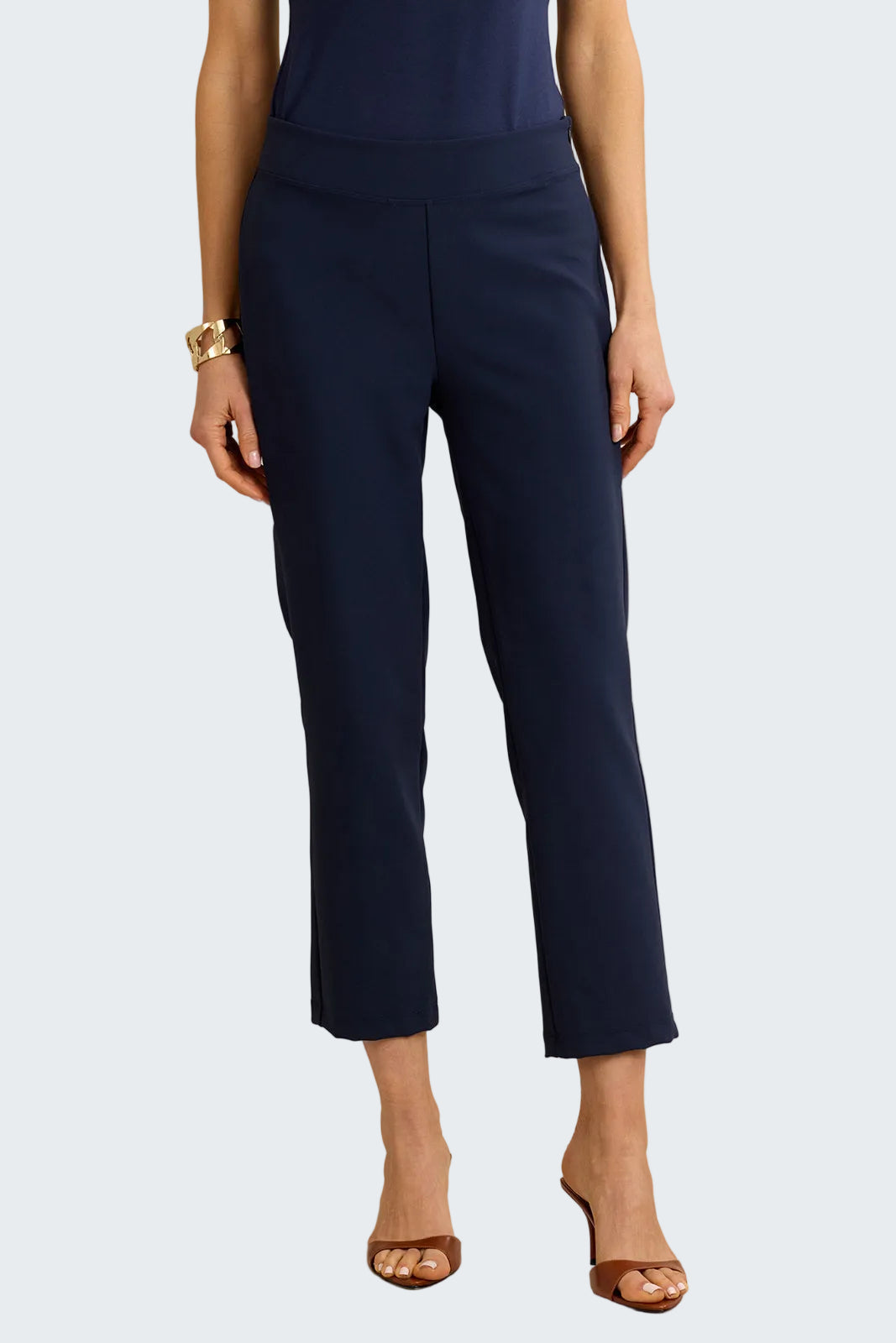 Navy blue pants worn by a person on a beige background