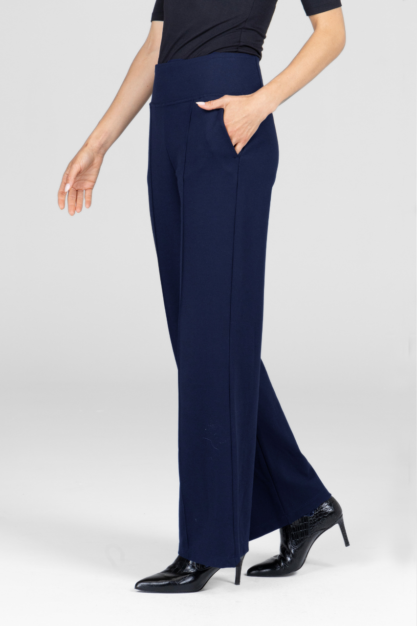 Navy blue pants worn by a person on a white background