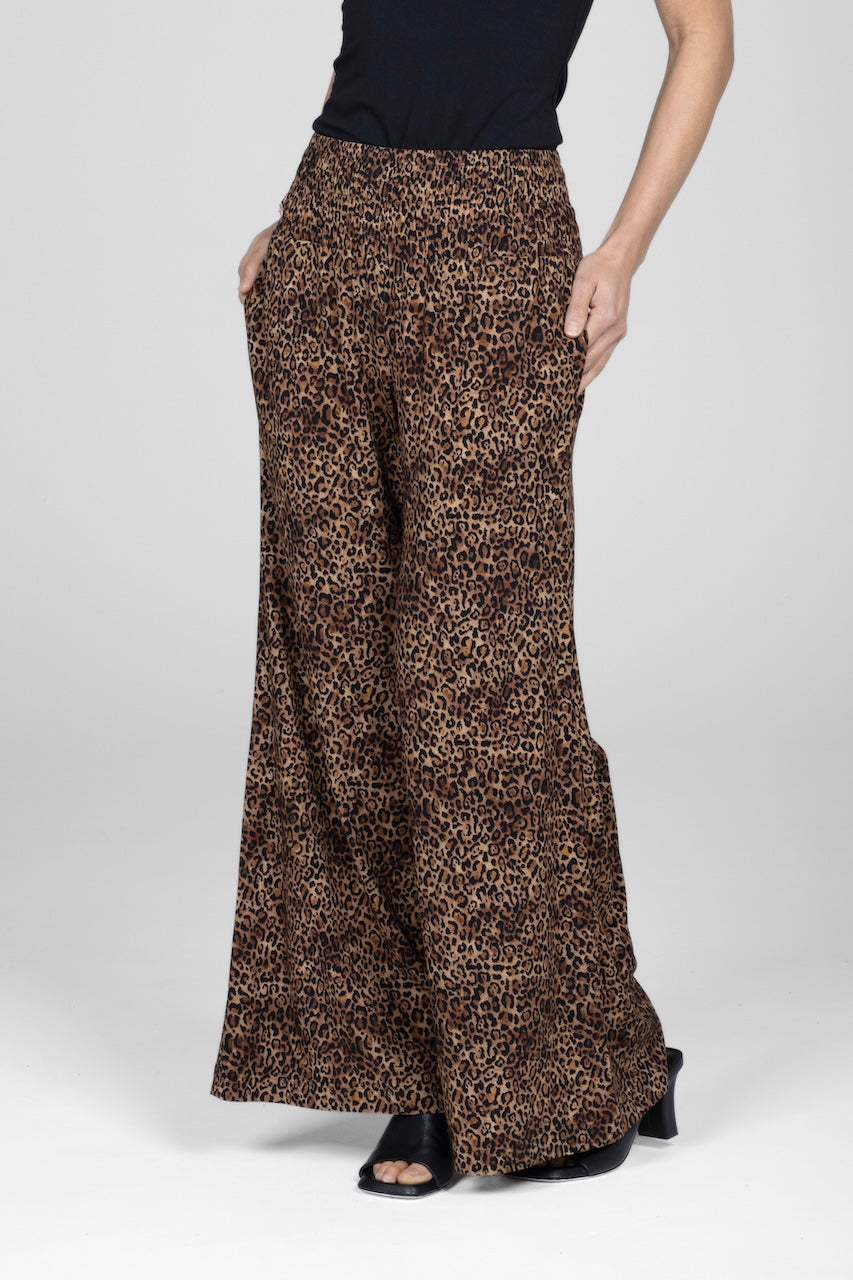 Leopard print wide-leg pants worn by a person on a white background