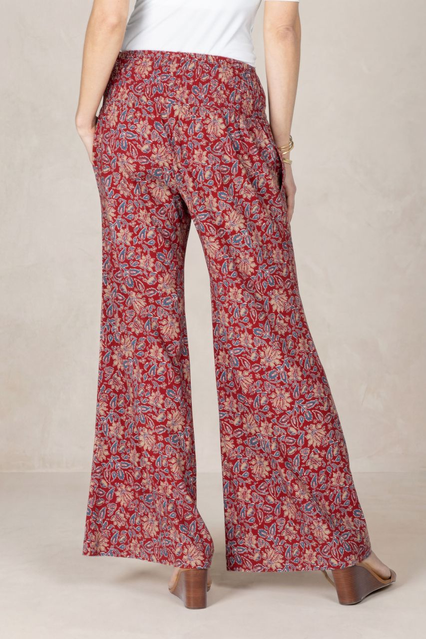 Floral-patterned pants worn by a person on a plain background