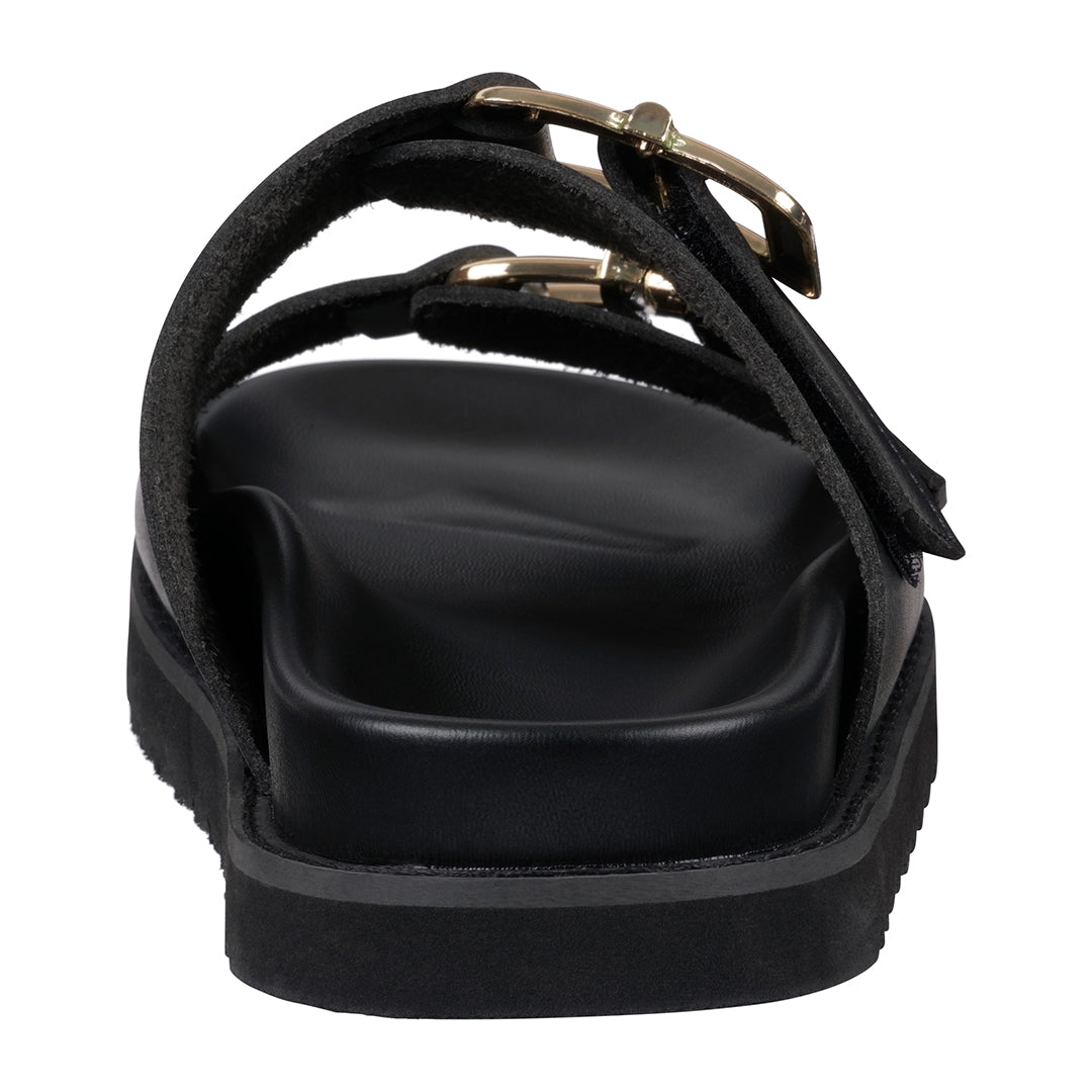 Black sandal with a strap and buckle on a white background