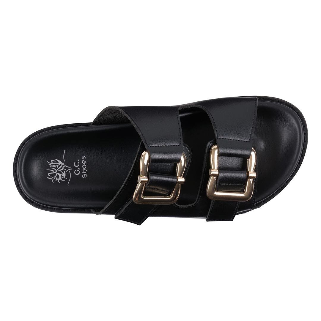 Black sandal with gold buckles on a white background