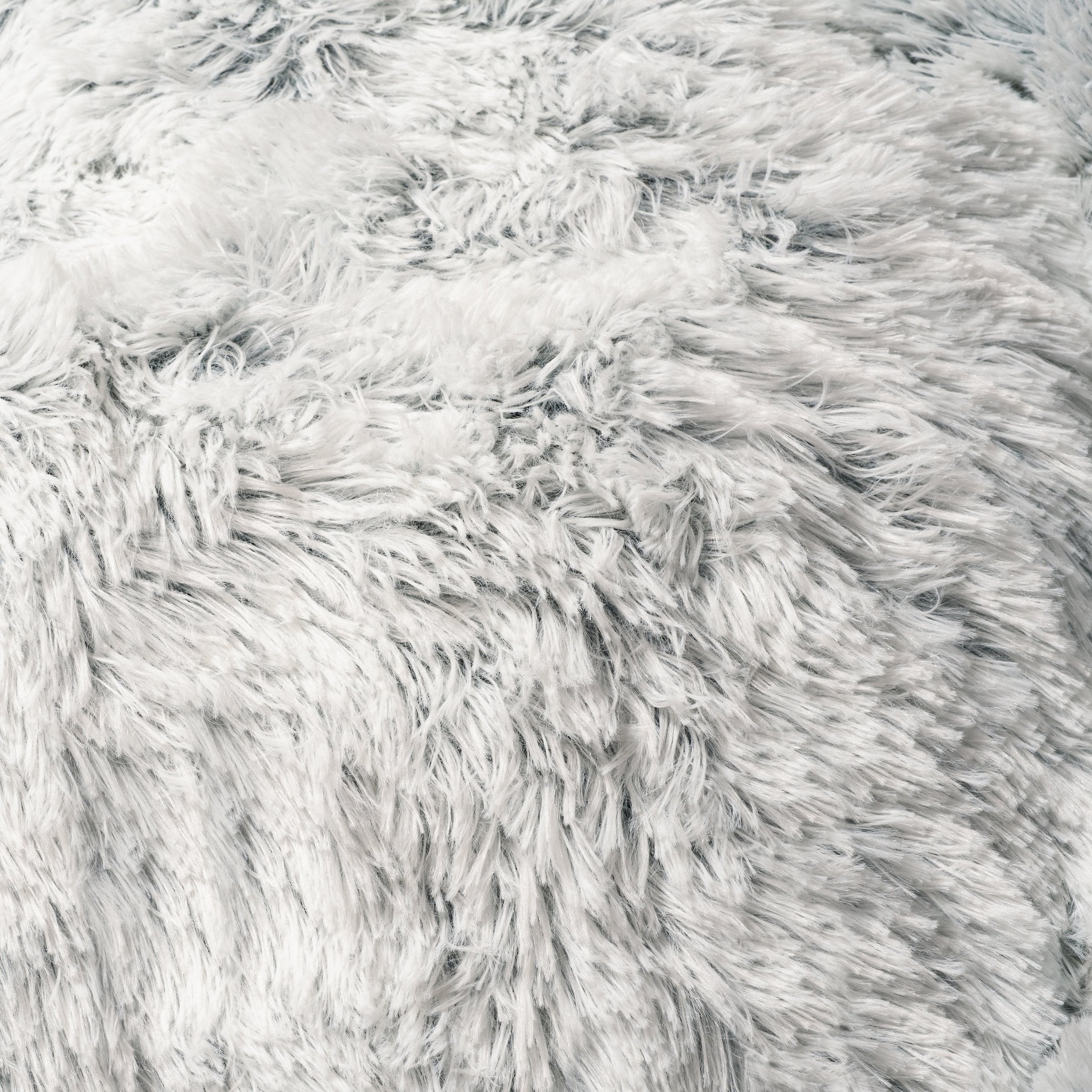 Close-up of a fluffy white rug with a soft texture.