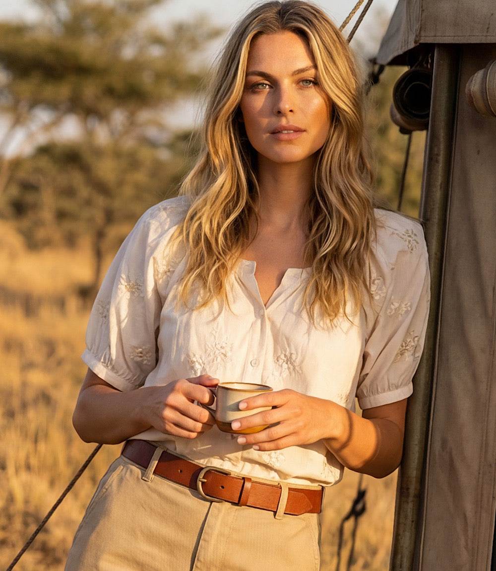 Woman holding a mug in a safari setting