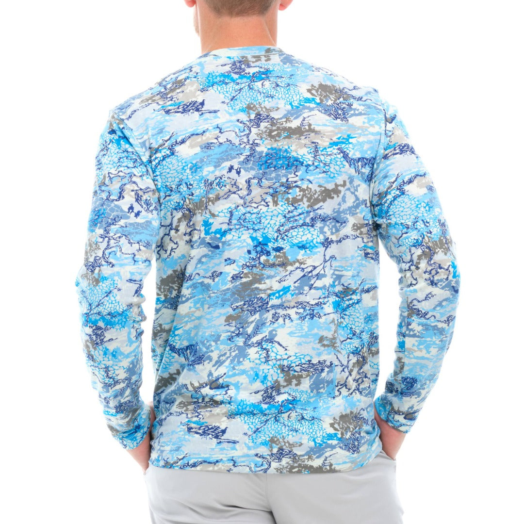 Person wearing a blue camouflage long-sleeve shirt on a white background