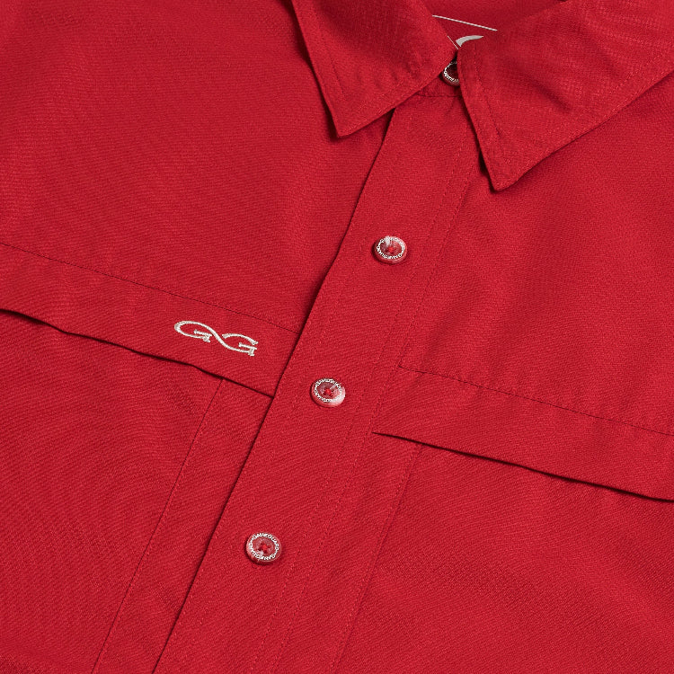 Close-up of a red shirt with a logo on the chest.
