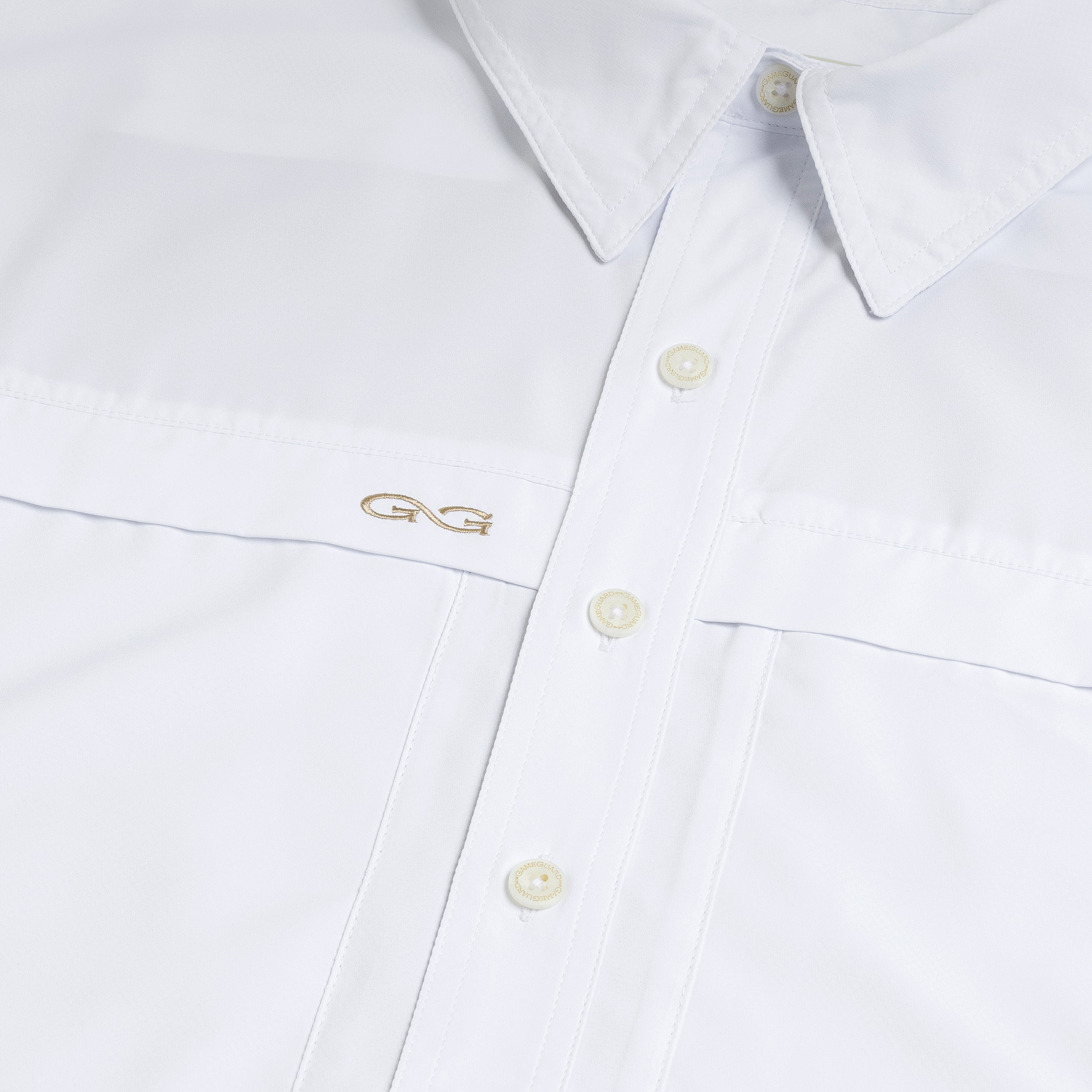 Close-up of a white shirt with a logo on the chest pocket.