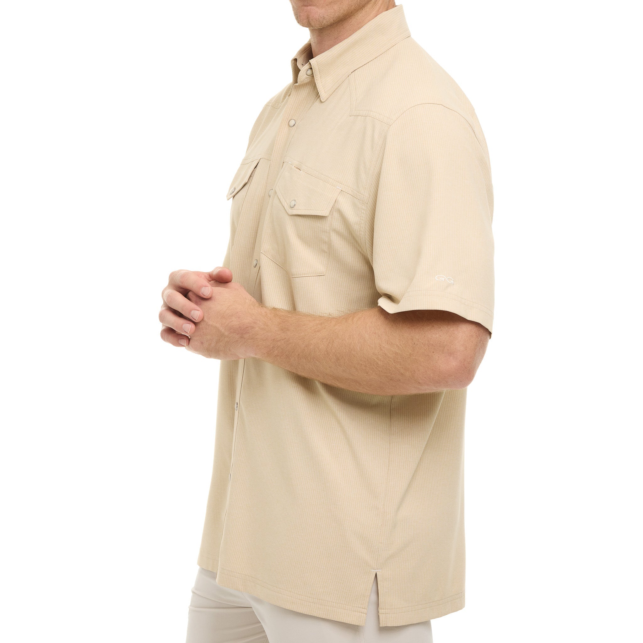 Beige short-sleeve shirt worn by a person on a white background