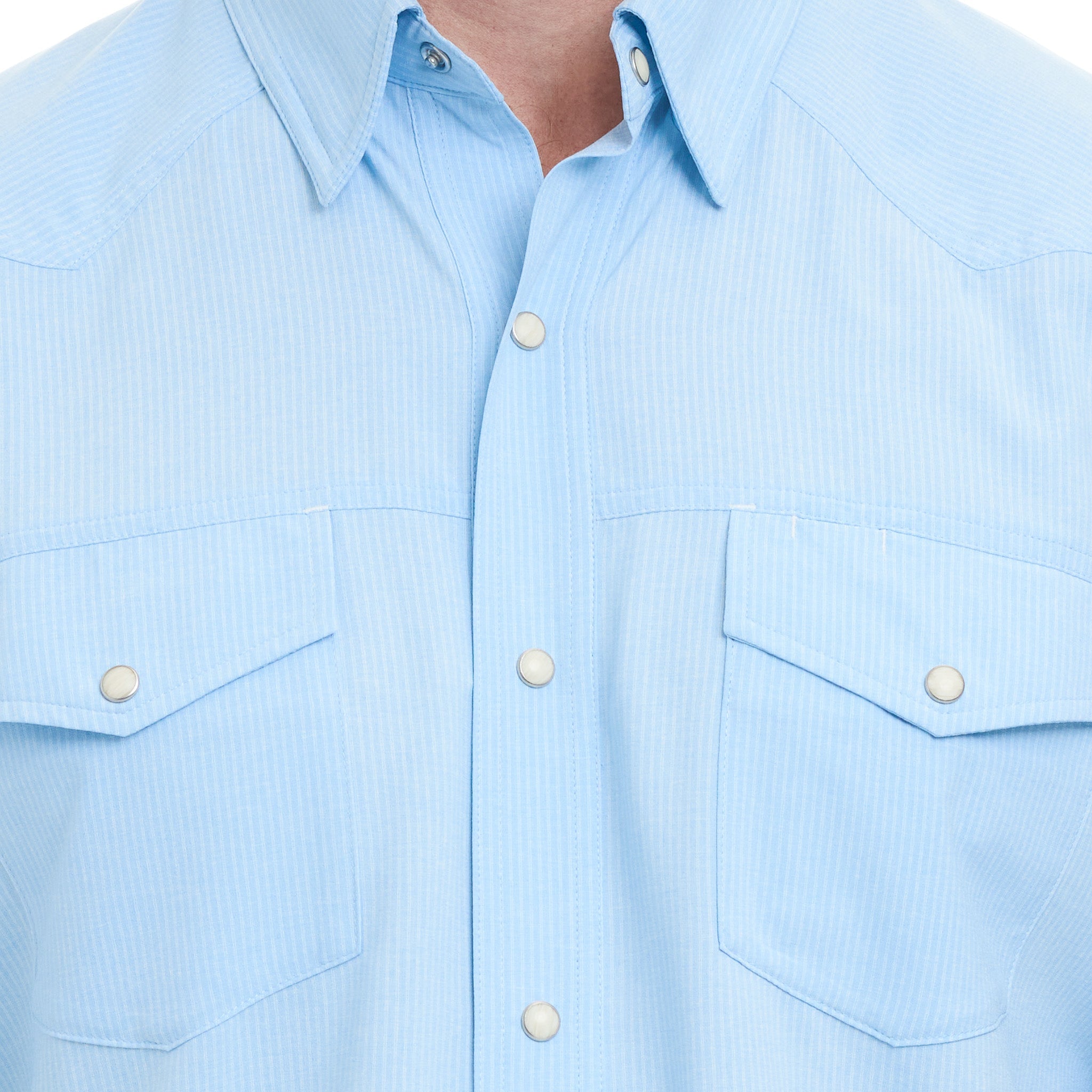 Light blue shirt with button details on a plain background