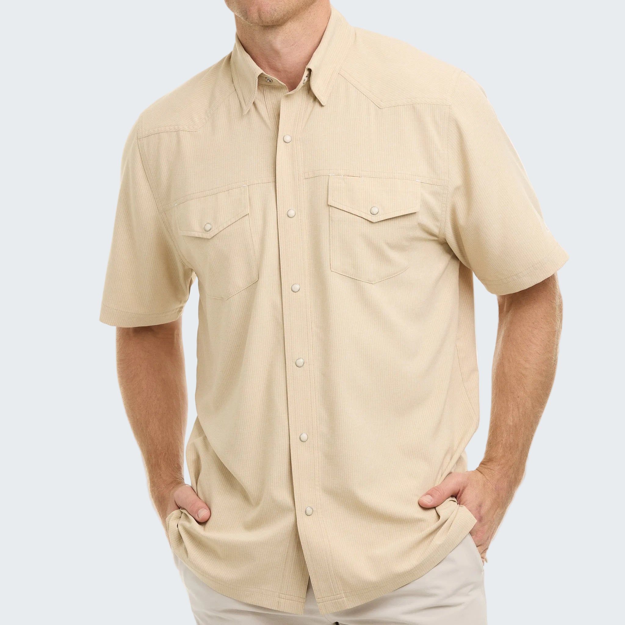 Man wearing a beige short-sleeve shirt on a white background