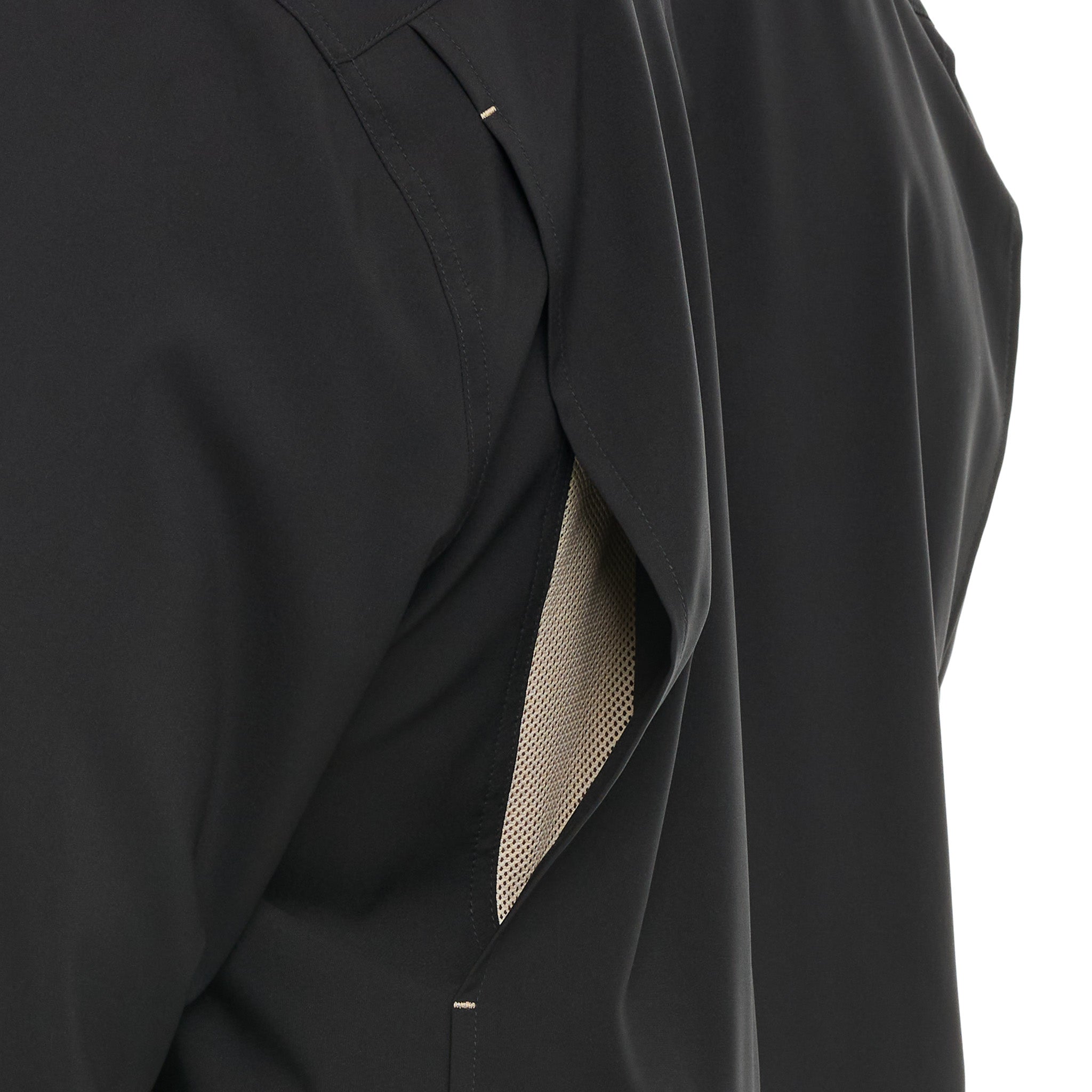Black coat with a textured tie detail on a white background