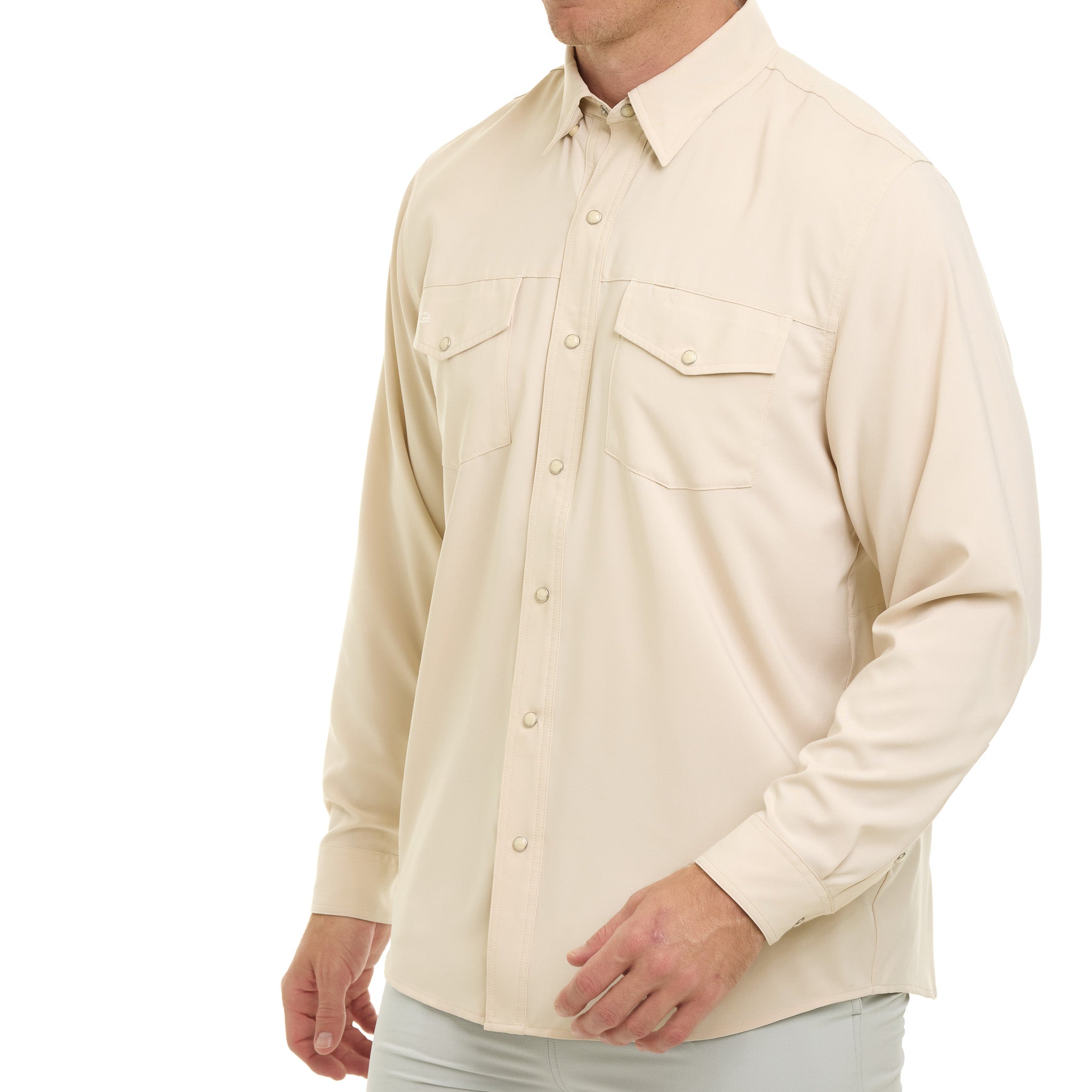 Beige button-up shirt worn by a person on a white background