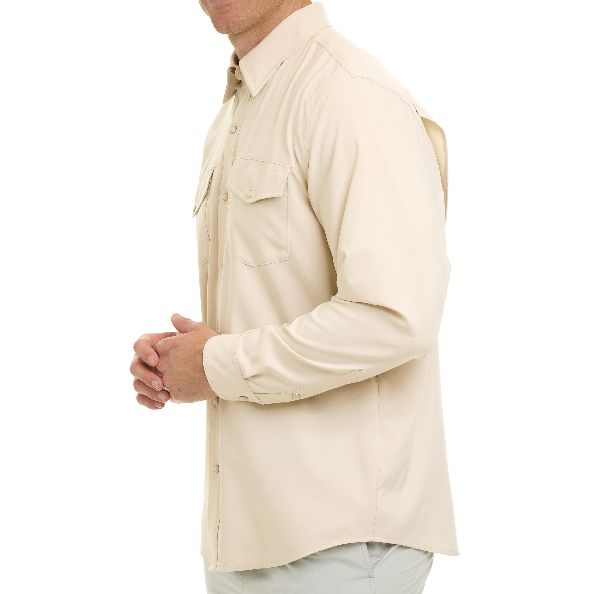 Beige long-sleeve shirt worn by a person on a white background