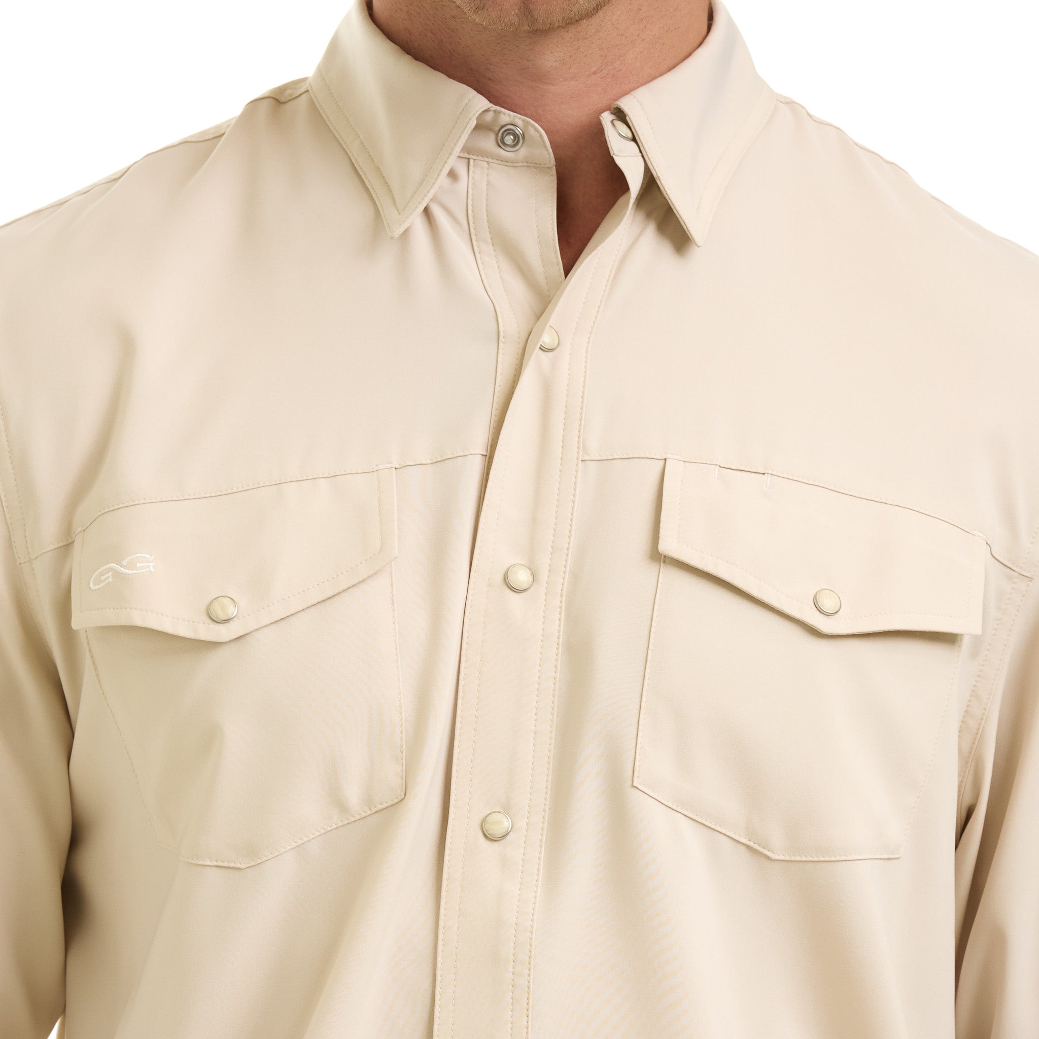 Beige button-up shirt with two front pockets on a white background