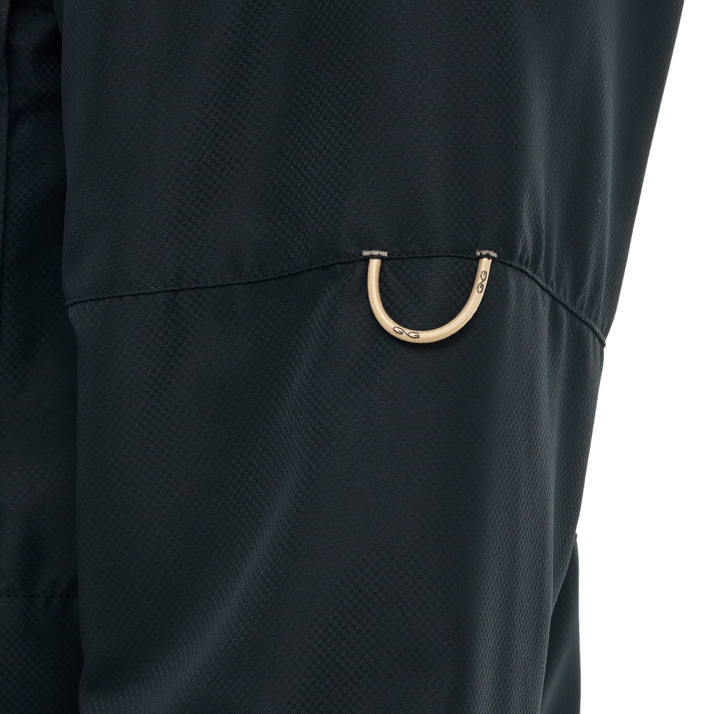 Close-up of a black jacket with a gold zipper pull on a white background
