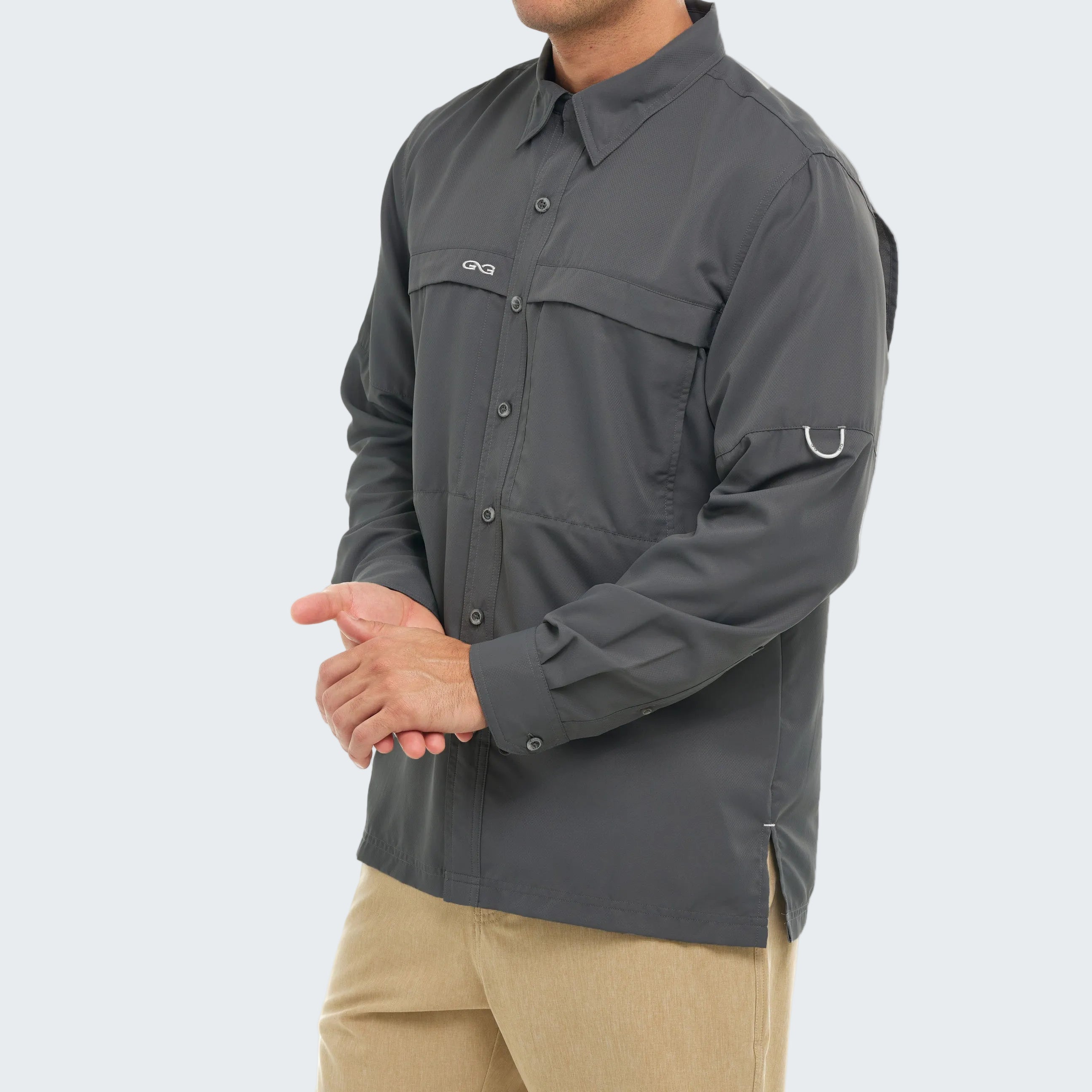 Person wearing a gray shirt with a brand logo on a white background