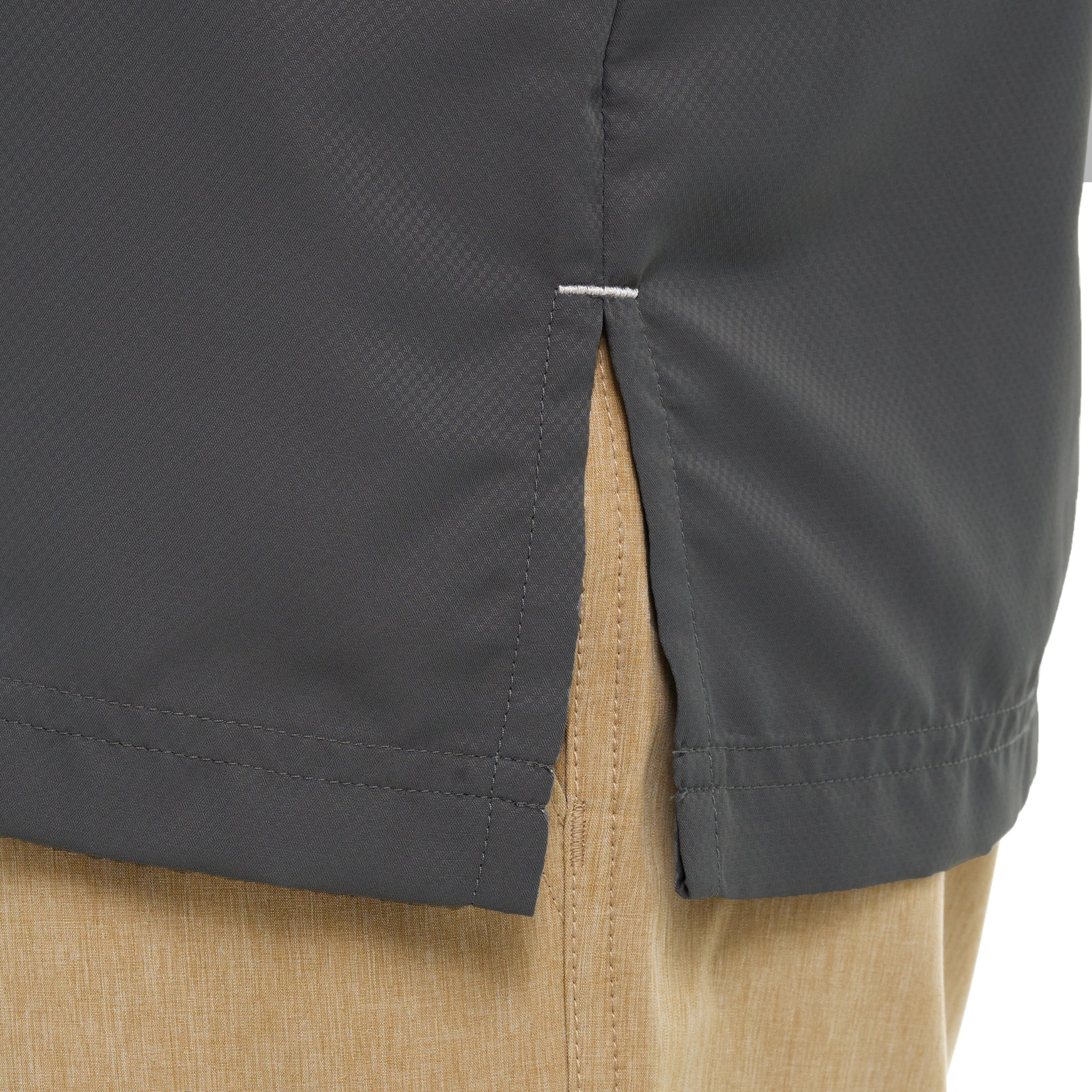 Close-up of a dark gray jacket with beige pants on a white background