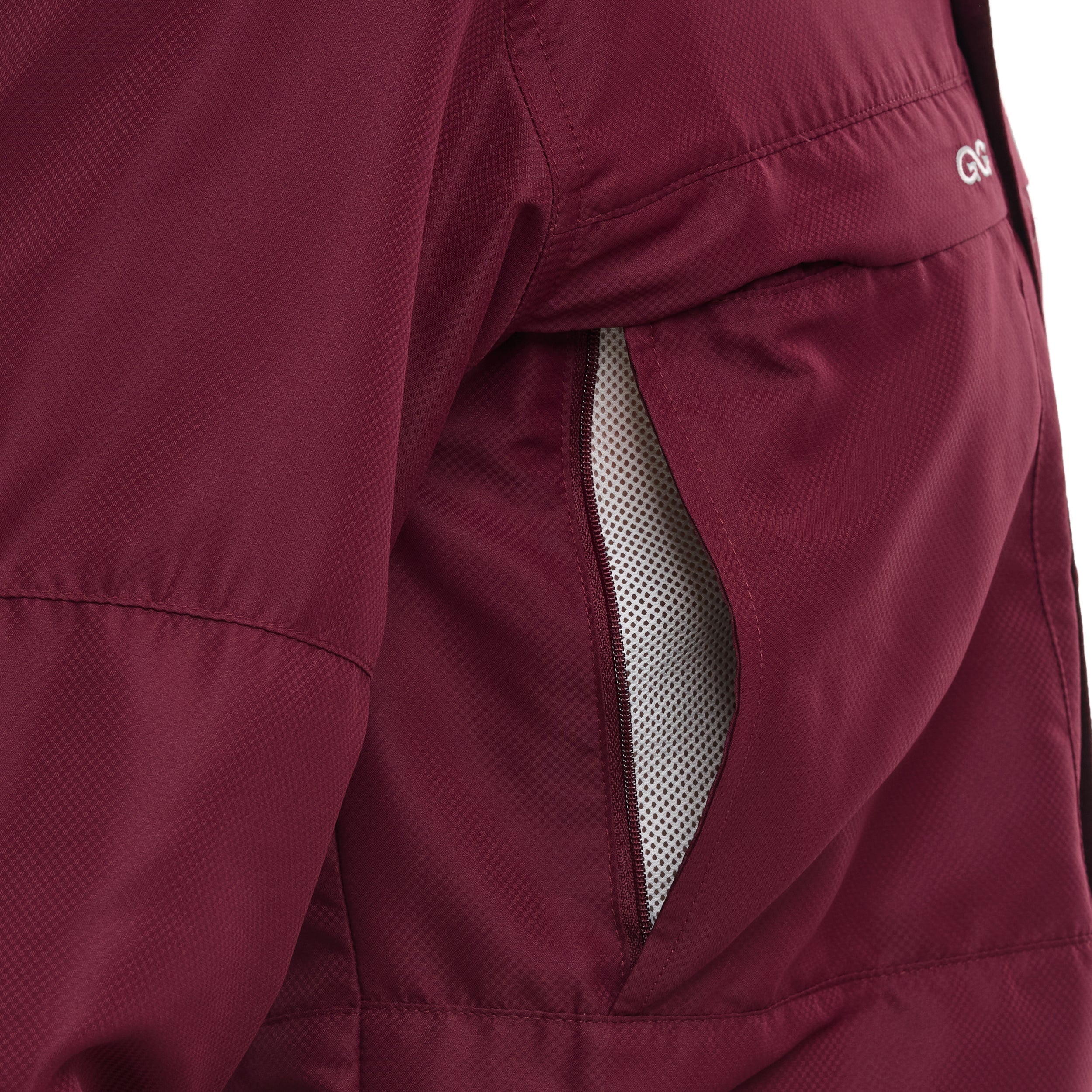 Close-up of a maroon jacket with a mesh panel on a white background