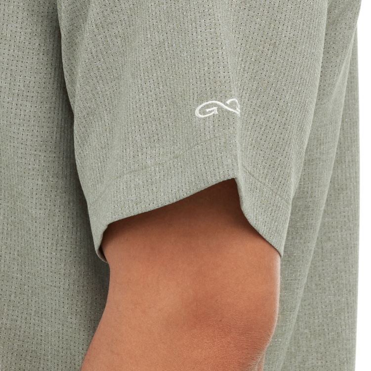 Close-up of a gray garment with a white logo on a plain background
