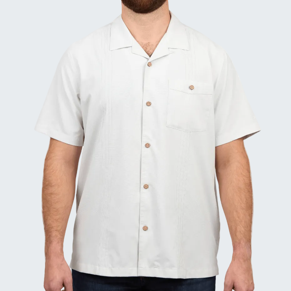 Man wearing a white short-sleeve button-up shirt on a white background