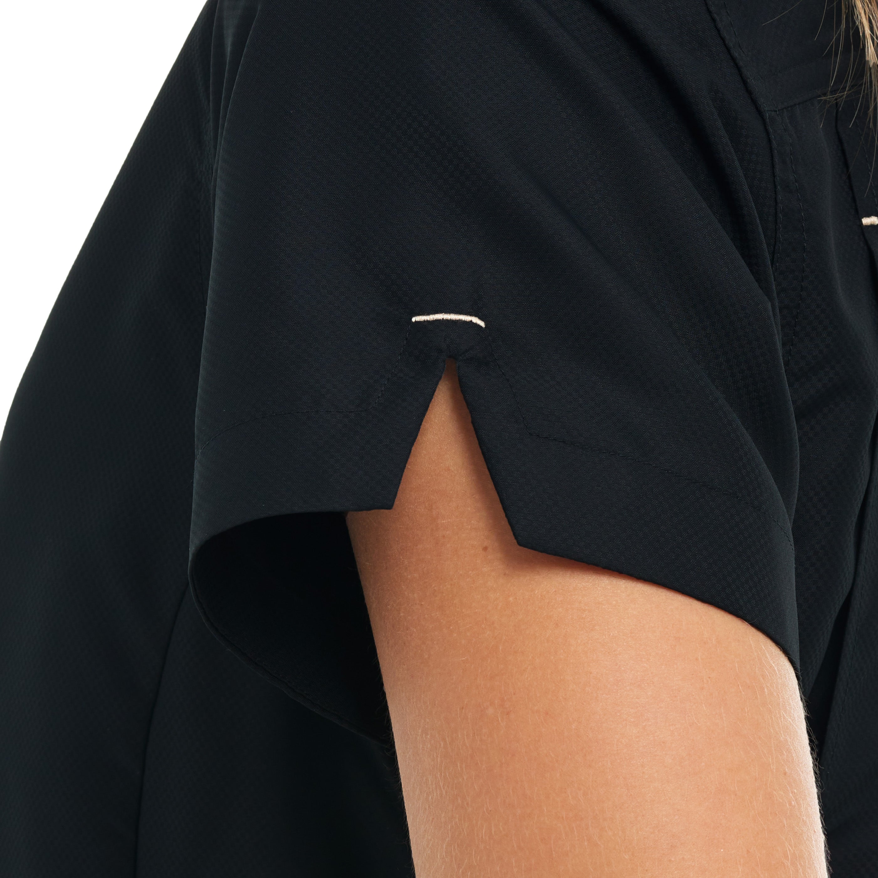 Close-up of a person wearing a black shirt with a white logo on a white background