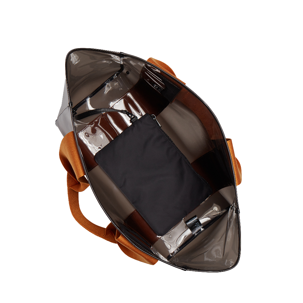 Spherical metallic object with brown leather strap on a white background