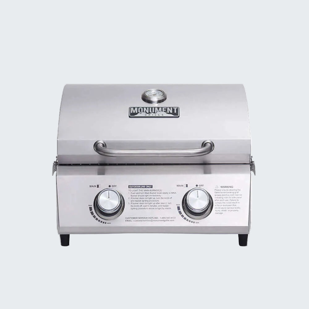 Stainless steel grill with 'Monument' branding on a white background