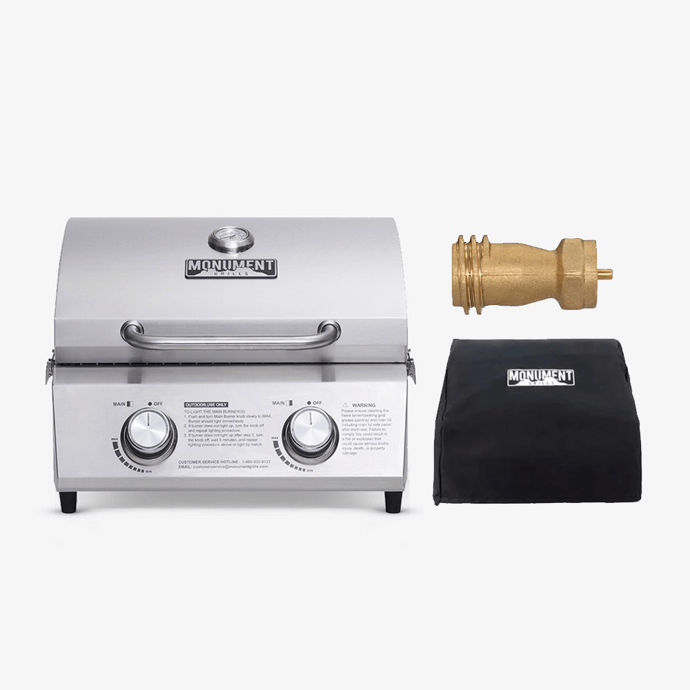 Stainless steel grill with brass valve and black cover on a white background