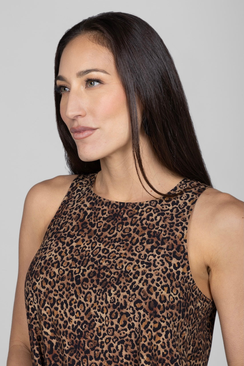Woman wearing a leopard print top against a plain background