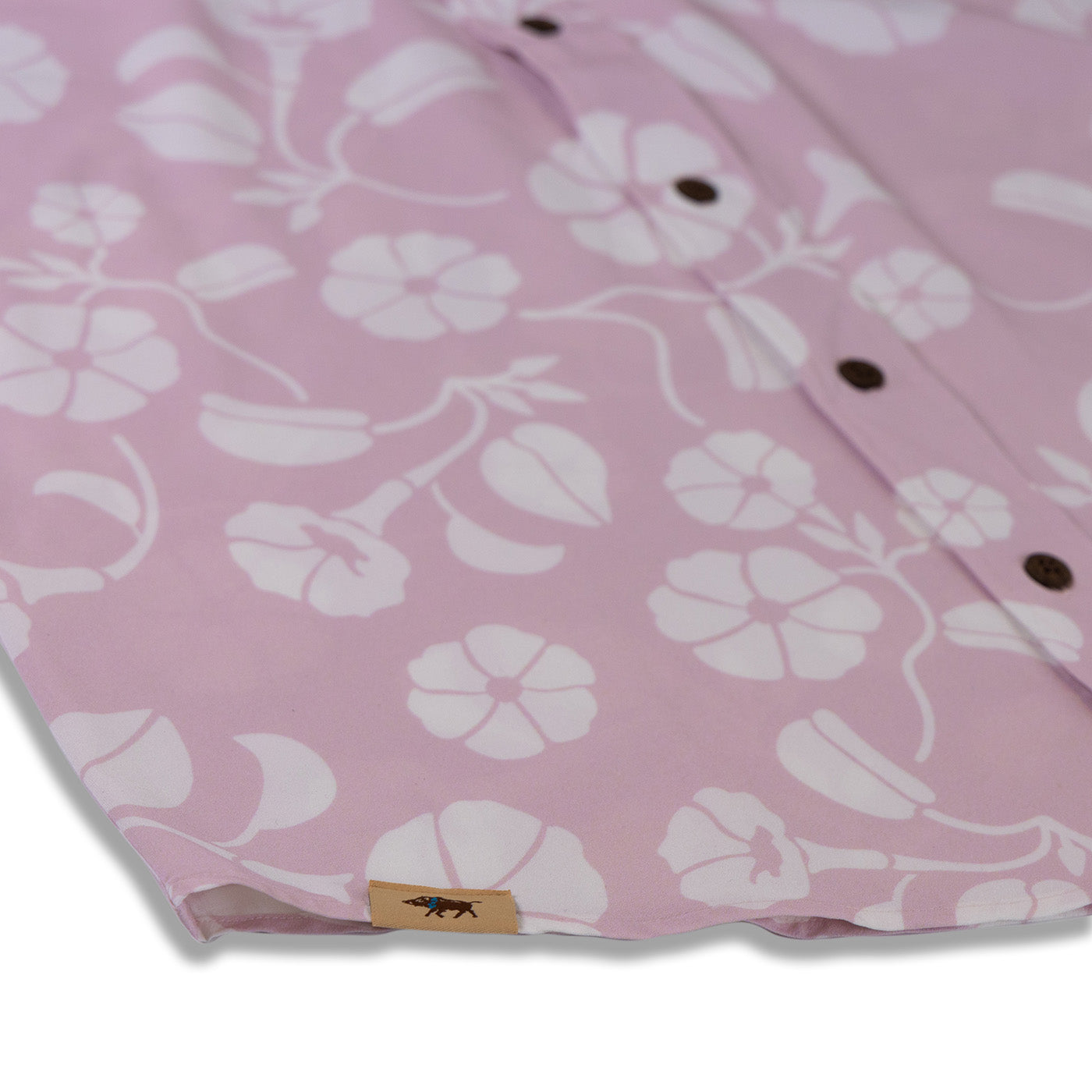 Pink floral shirt with a brand label on a white background