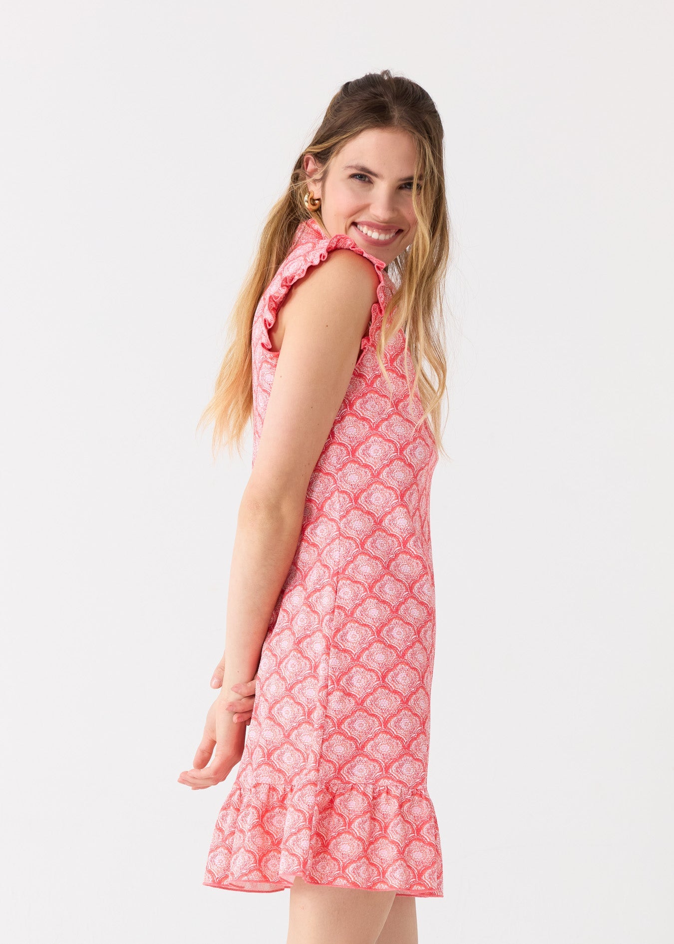 Woman wearing a pink dress with a white background