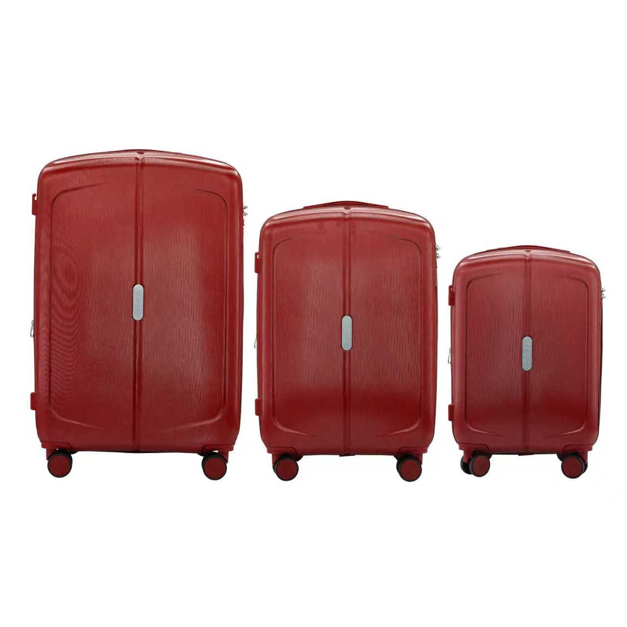 Three red suitcases of different sizes on a white background