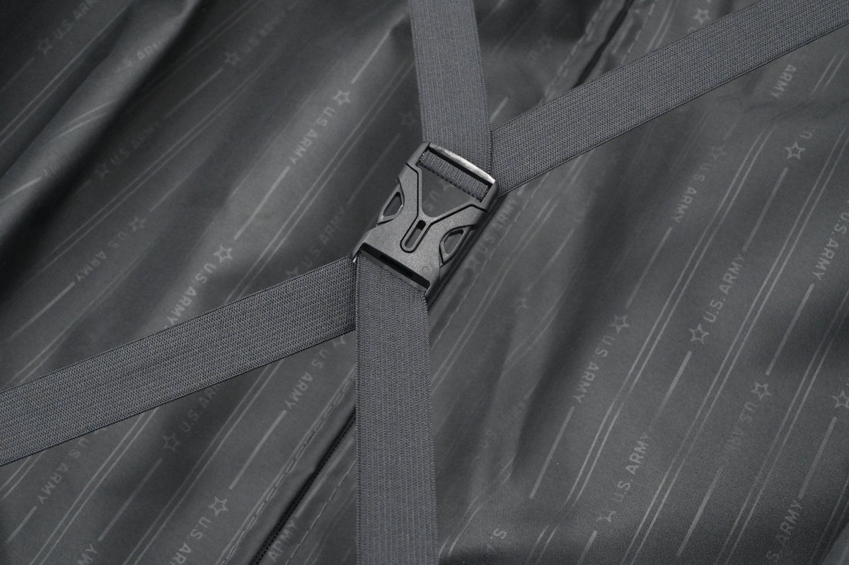 Close-up of a gray strap with a buckle on a textured gray background