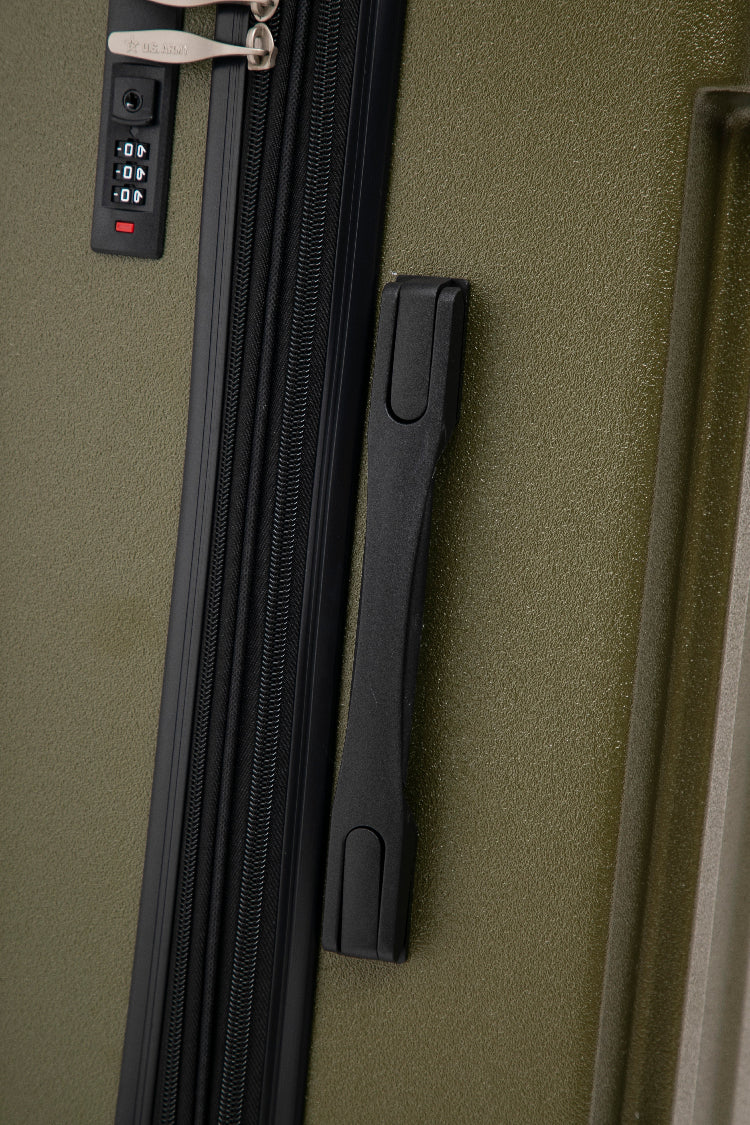 Close-up of a green suitcase with a zipper and handle
