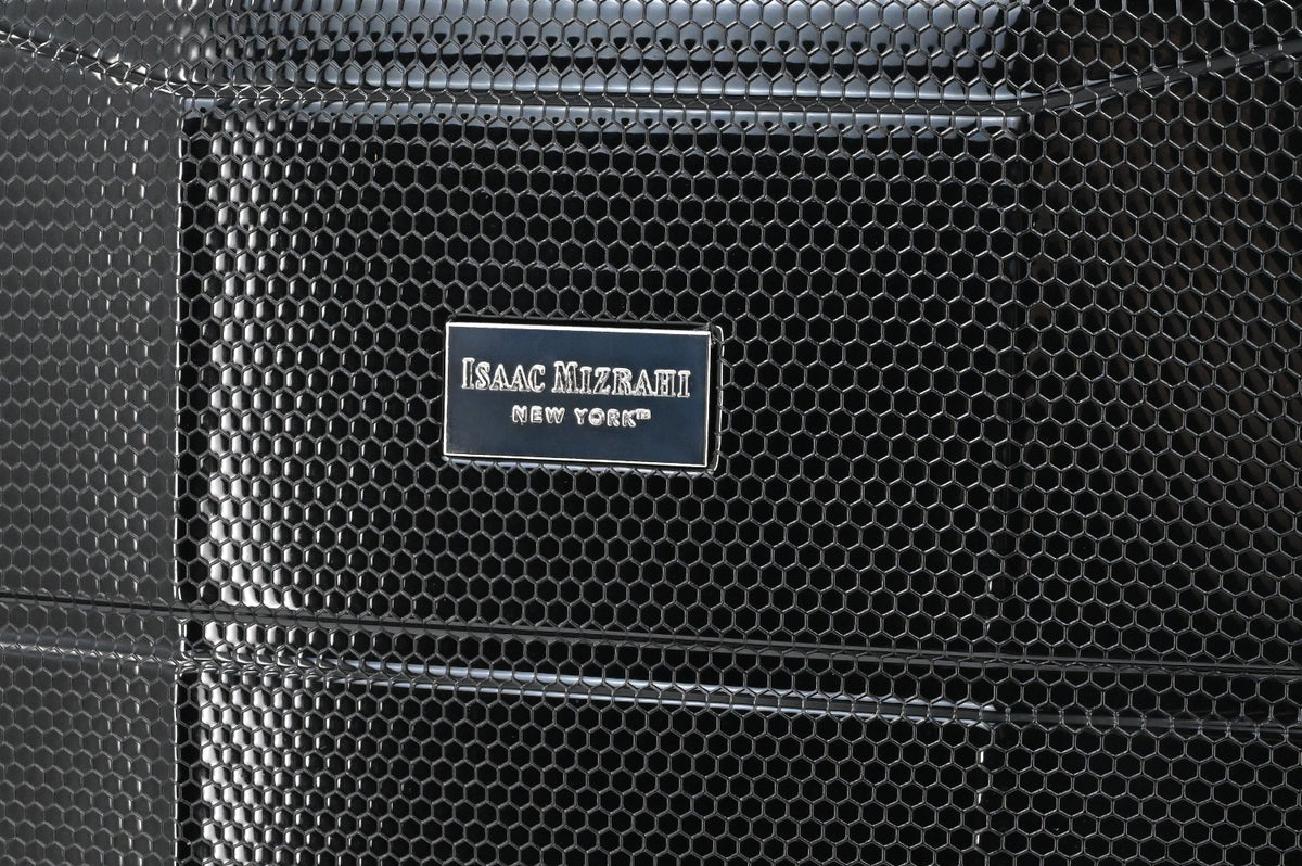 Close-up of a textured black surface with 'Isaac Mizrahi New York' label.