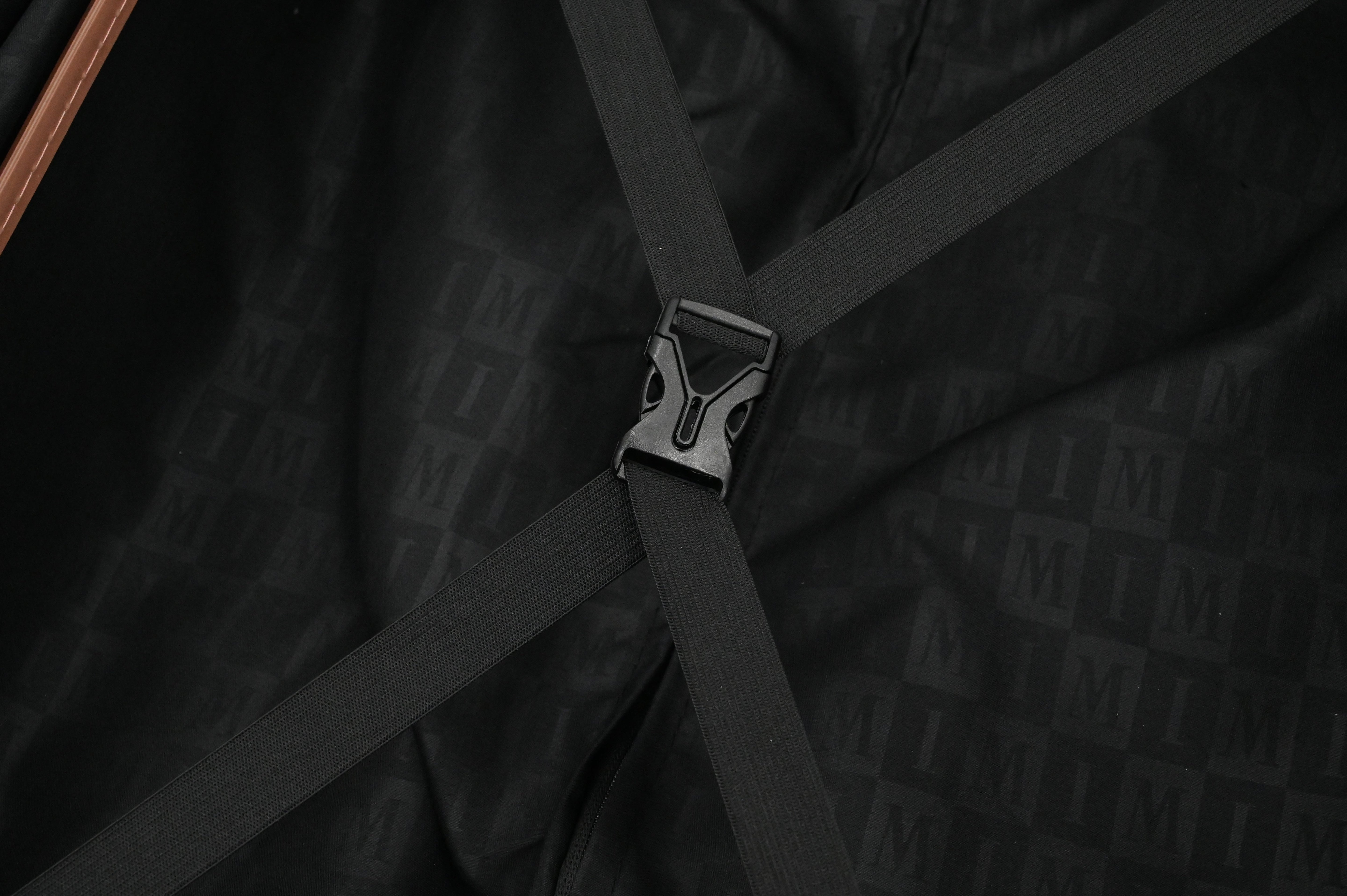 Close-up of a black strap with a buckle on a dark textured background