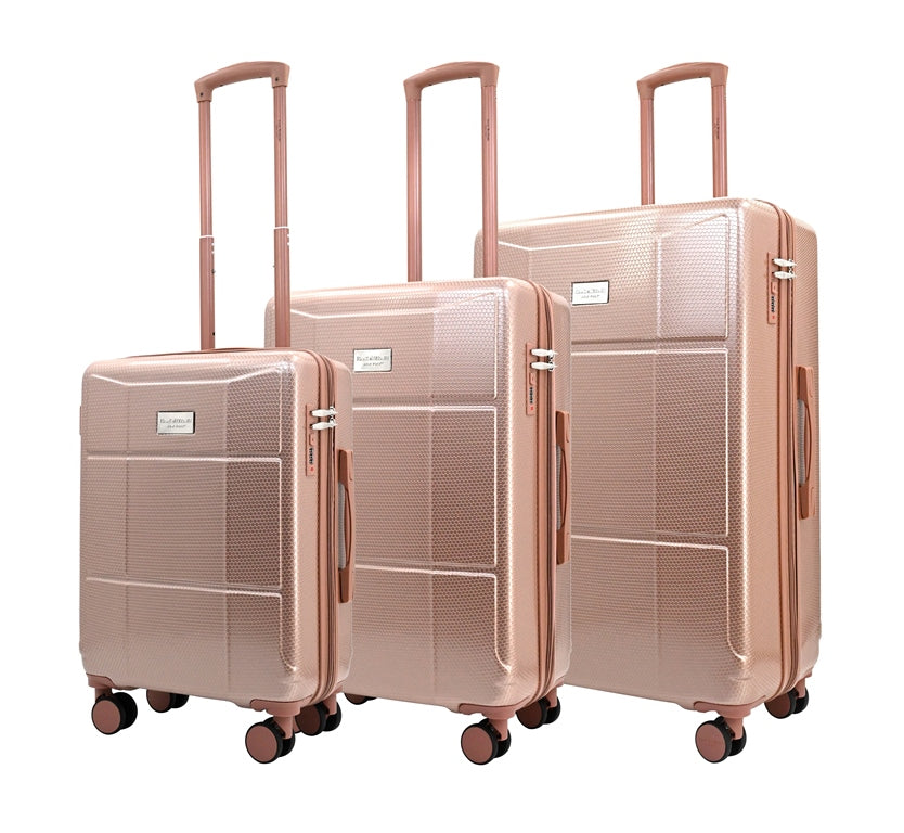 Set of three rose gold suitcases on a white background