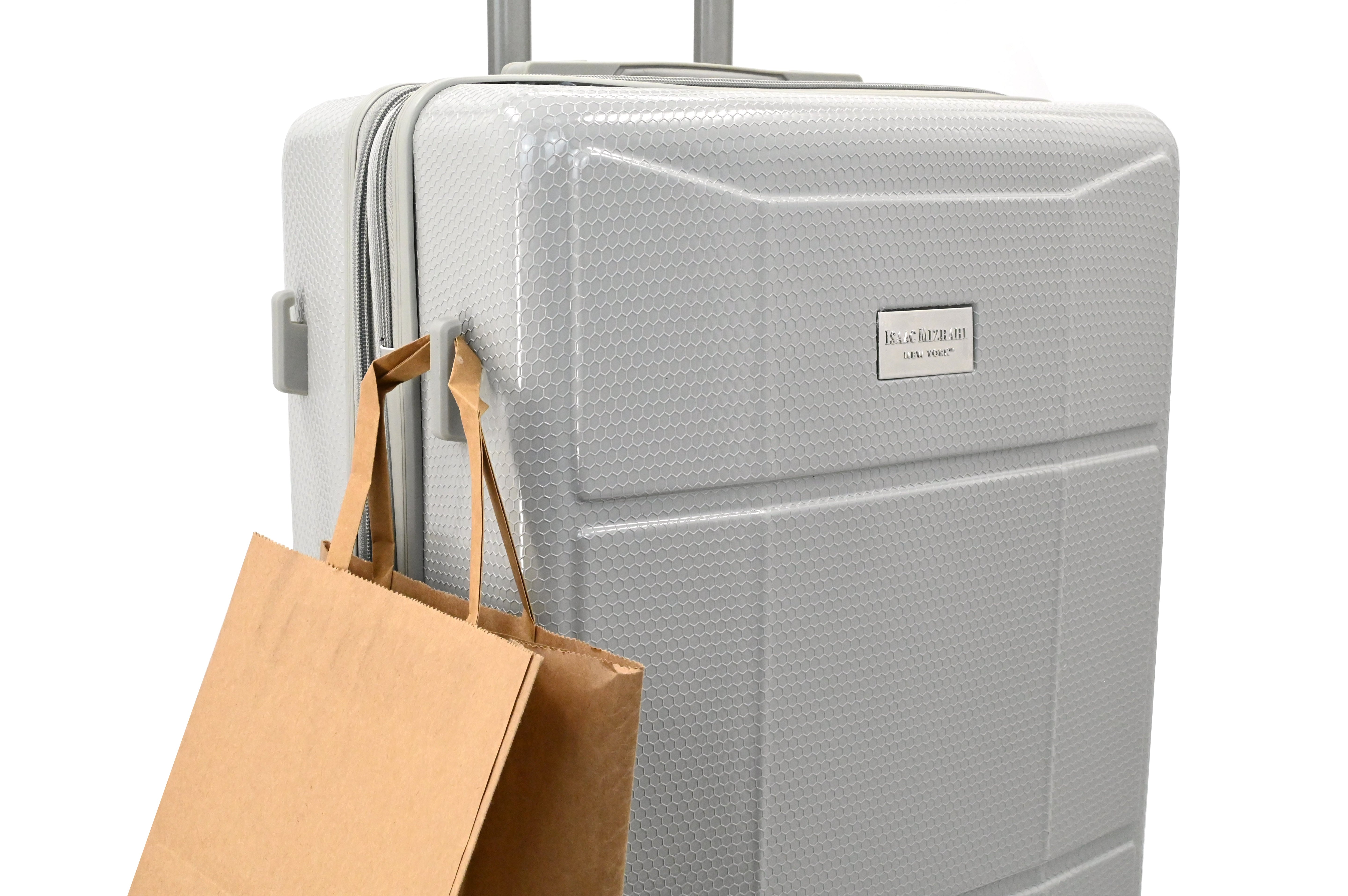 Gray suitcase with a brown paper bag on a white background